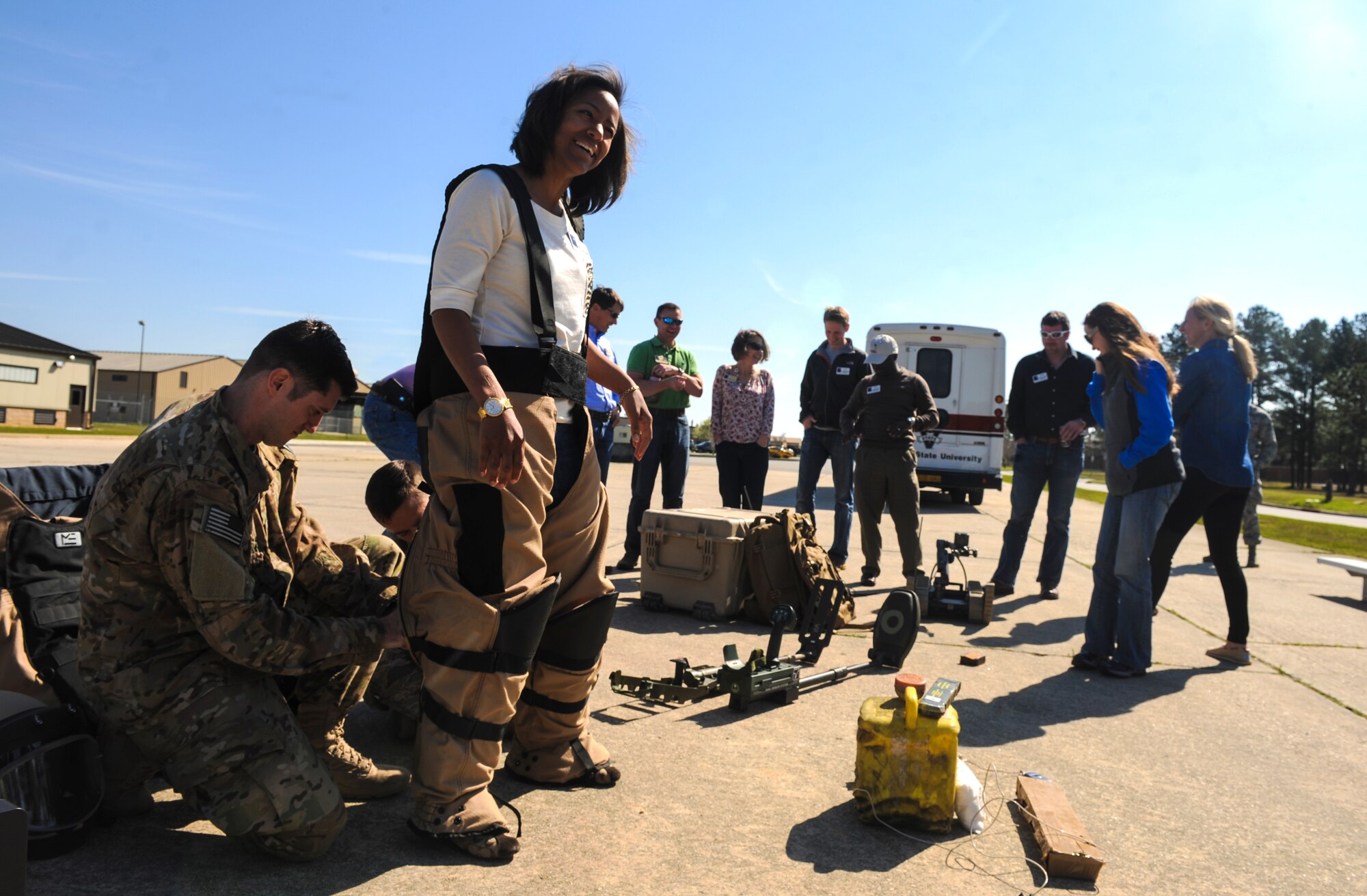 U.S. Air Force Tech. Sgt. Brandon Sawyer, 23d Civil Engineer Squadron explosive ordnance disposal (EOD), helps Denitra Allen Hardnett, member of Leadership Georgia, try on an EOD suit at Moody Air Force Base Ga., March 21, 2014. Approximately 185 members of Leadership Georgia visited several units on base and got a chance to see Moody’s mission capabilities firsthand. (U.S. Air Force photo by Senior Airman Olivia Bumpers/Released)