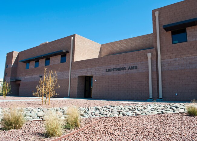 The new F-35 Lightning Aircraft Maintenance Unit hangar was officially opened during a ribbon cutting ceremony March 18, 2014, at Nellis Air Force Base Nev. The new AMU hangar will ease operations for maintaining the F-35 Lightning II. The hangars new features include climate control and overhead crane access. (U.S. Air Force photo by Airman 1st Class Thomas Spangler)  