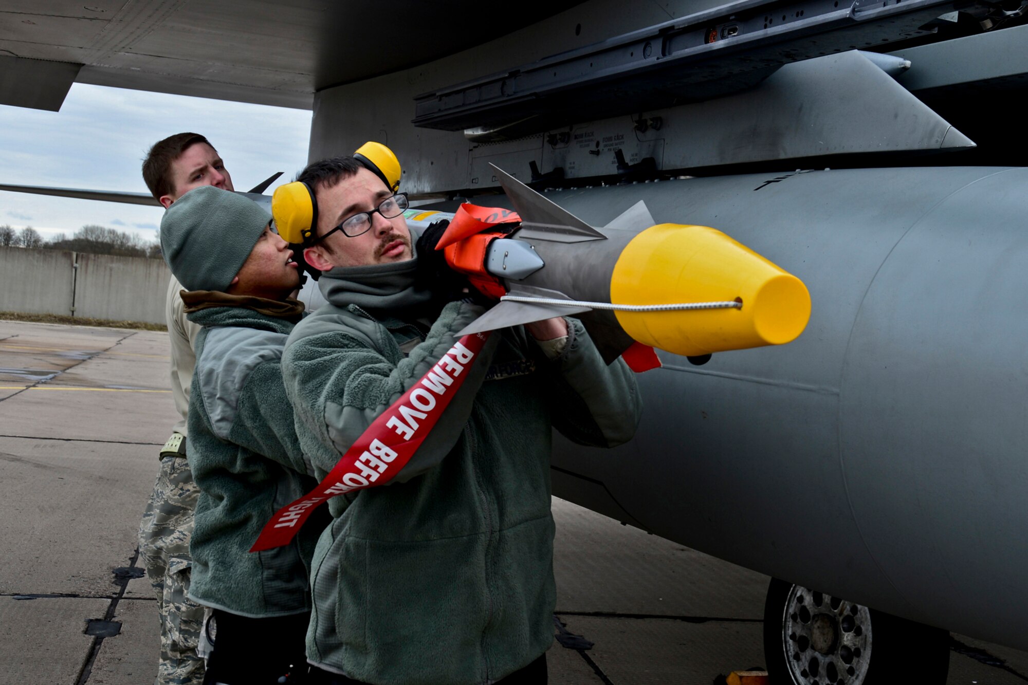 A weapons load crew from the 48th Air Expeditionary Group, mounts an AIM-9X air-to-air missile on to an F-15C Eagle at Šiauliai Air Base, Lithuania, March 19, 2014. The 493rd Expeditionary Fighter Squadron regularly flies training missions while deployed to maintain readiness and proficiency. The U.S. Air Force F-15C Eagles' participation in the NATO Baltic Air Policing mission helps ensure a safe and stable future for the Baltics while preserving the integrity of NATO's borders and NATO security. (U.S. Air Force photo by Airman 1st Class Dana J. Butler/Released)