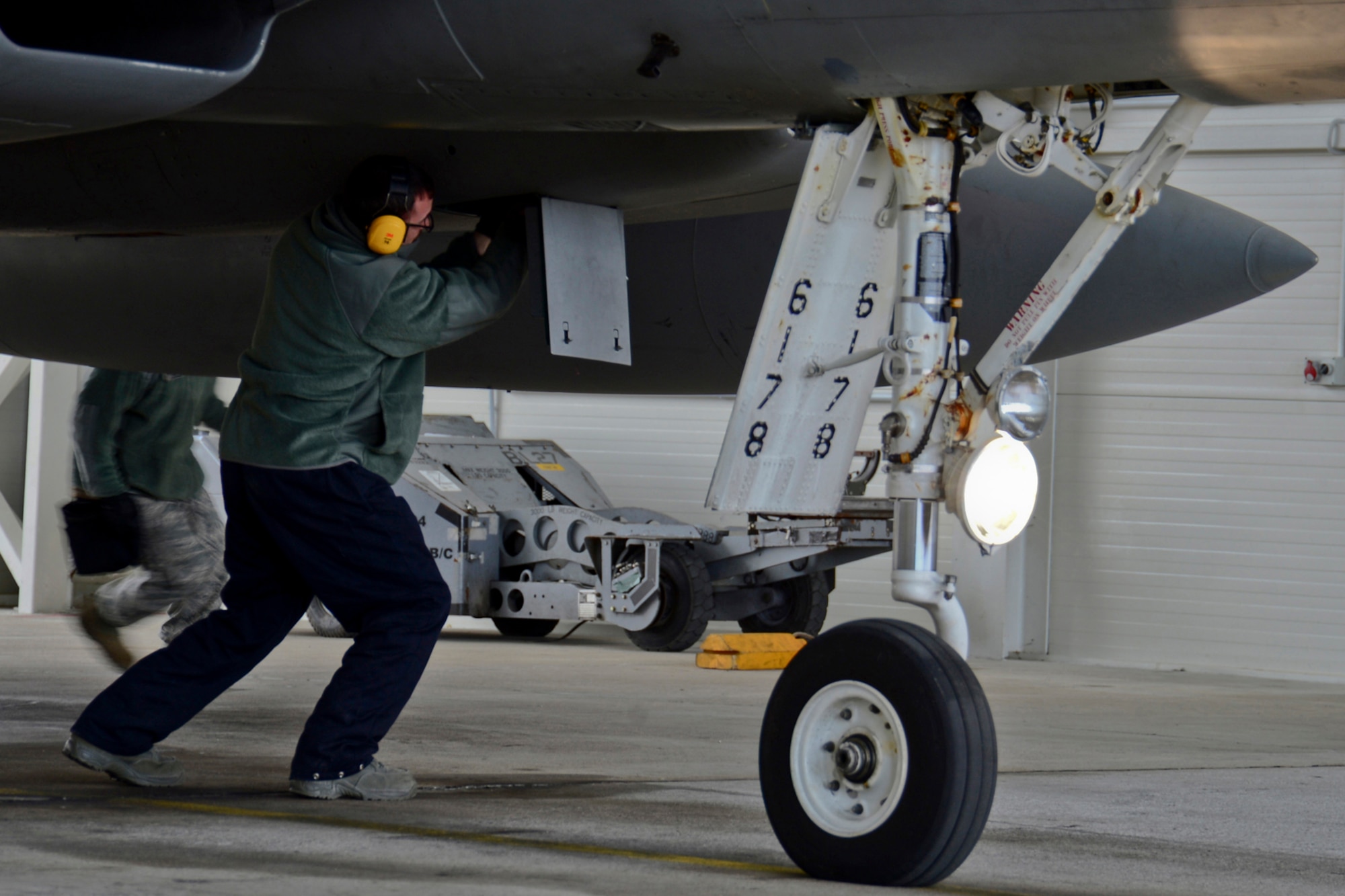 Senior Airman Jared Gregory, 48th Air Expeditionary Group weapons load crew member, performs pre-flight checks on an F-15C Eagle during a scramble training mission at Šiauliai Air Base, Lithuania, March 19, 2014. The 493rd Expeditionary Fighter Squadron regularly flies training missions while deployed to maintain readiness and proficiency. The U.S. Air Force F-15C Eagles' participation in the NATO Baltic Air Policing mission helps ensure a safe and stable future for the Baltics while preserving the integrity of NATO's borders and NATO security. (U.S. Air Force photo by Airman 1st Class Dana J. Butler)