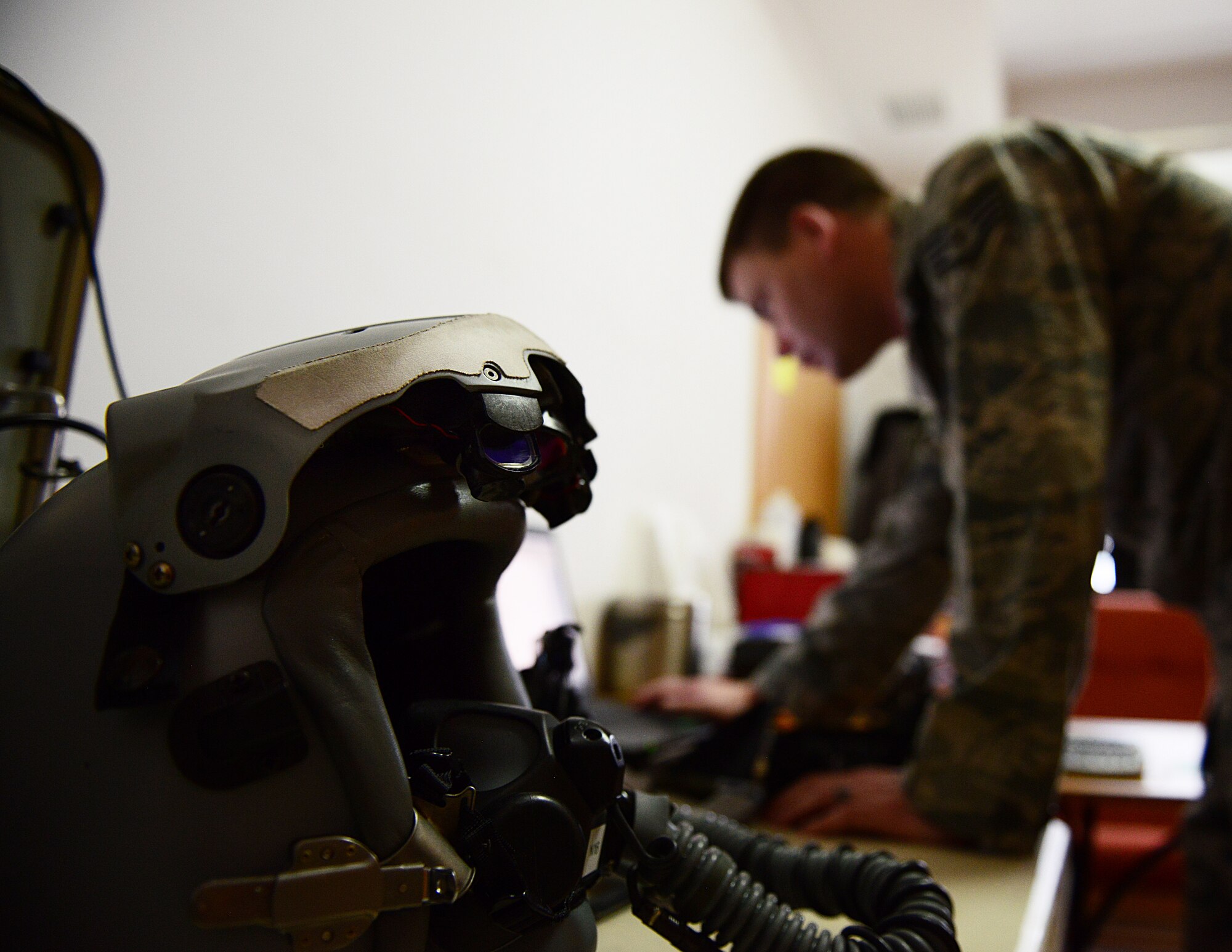 Staff Sgt. James Haney, 31st Operations Support Squadron aircrew flight equipment technician, checks on the functionality of a lightweight HGU-55/P combat edge pilot helmet, March 19, 2014, at Lask Air Base, Poland. In addition to a visual inspection, every item is then put through a functional test and checked for quality assurance before being deemed worthy for use. (U.S. Air Force photo/Airman 1st Class Ryan Conroy)   