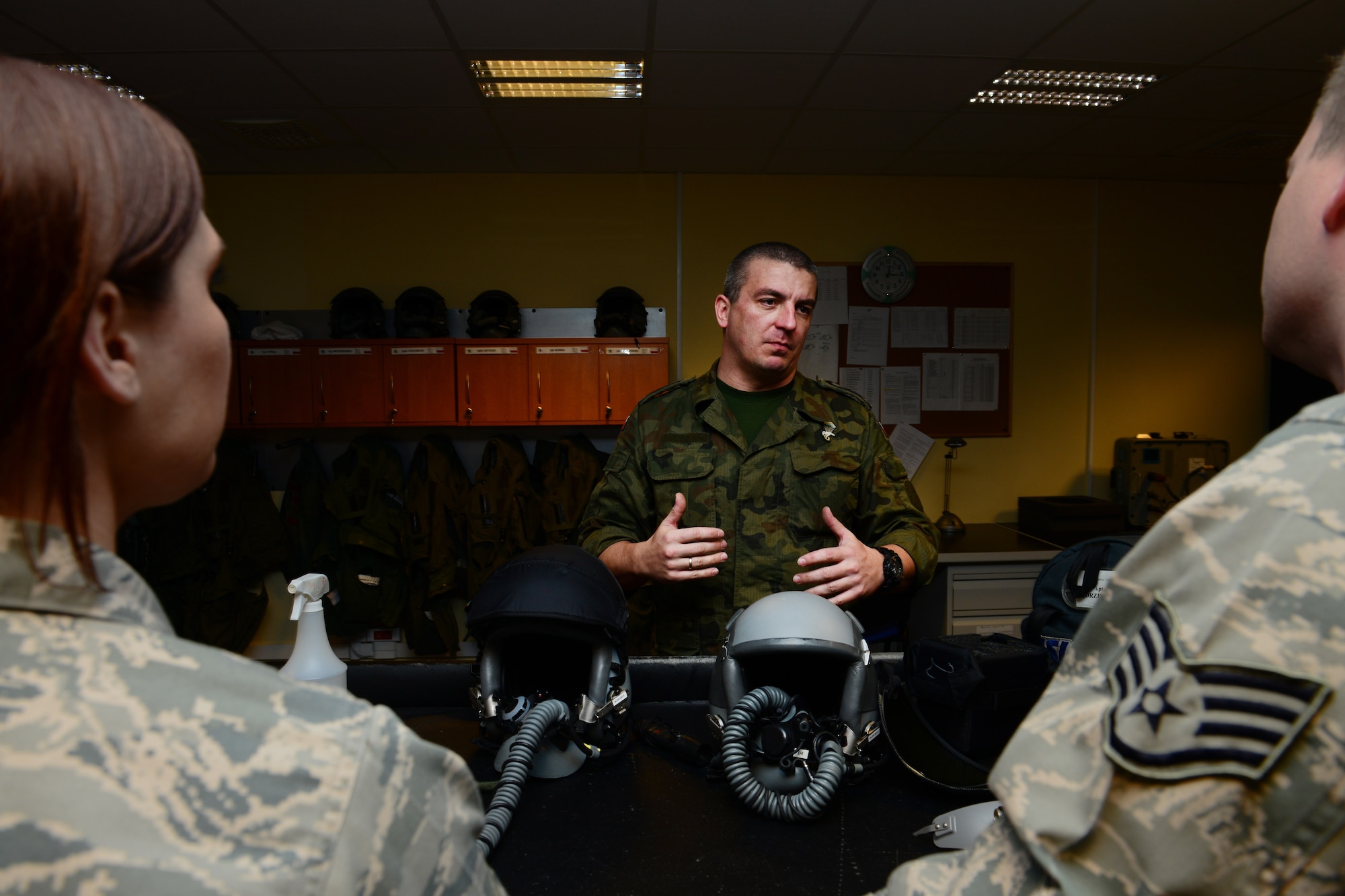 Polish air force Tech. Sgt. Tomasz Kunicki, life support operations flight, showcases aircrew flight equipment and fields questions from U.S. Air Force AFE Airmen, March 20, 2014, at Lask Air Base, Poland. Airmen assigned to Aviano Air Base, Italy, toured AFE facilities in Poland to gain an understanding of the mission, field questions from NATO partners and promote interoperability throughout the ranks. (U.S. Air Force photo/Airman 1st Class Ryan Conroy)