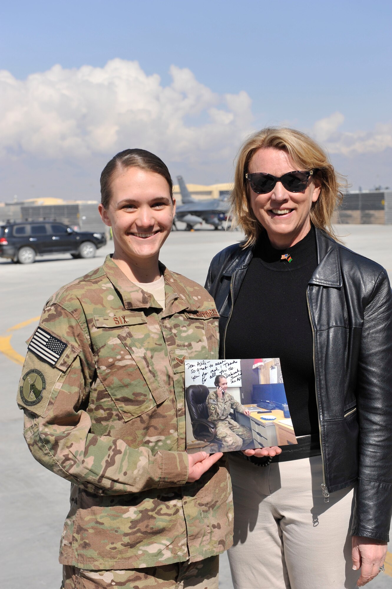 Airman 1st Class Ashli Six holds a photograph that Secretary of the Air Force Deborah Lee James autographed for her at Bagram Airfield, Afghanistan, March 22, 2014. The picture was of Six on the phone after receiving a call from James on New Year’s Eve 2013. (U.S. Air Force photo by Senior Master Sgt. Gary J. Rihn/Released)