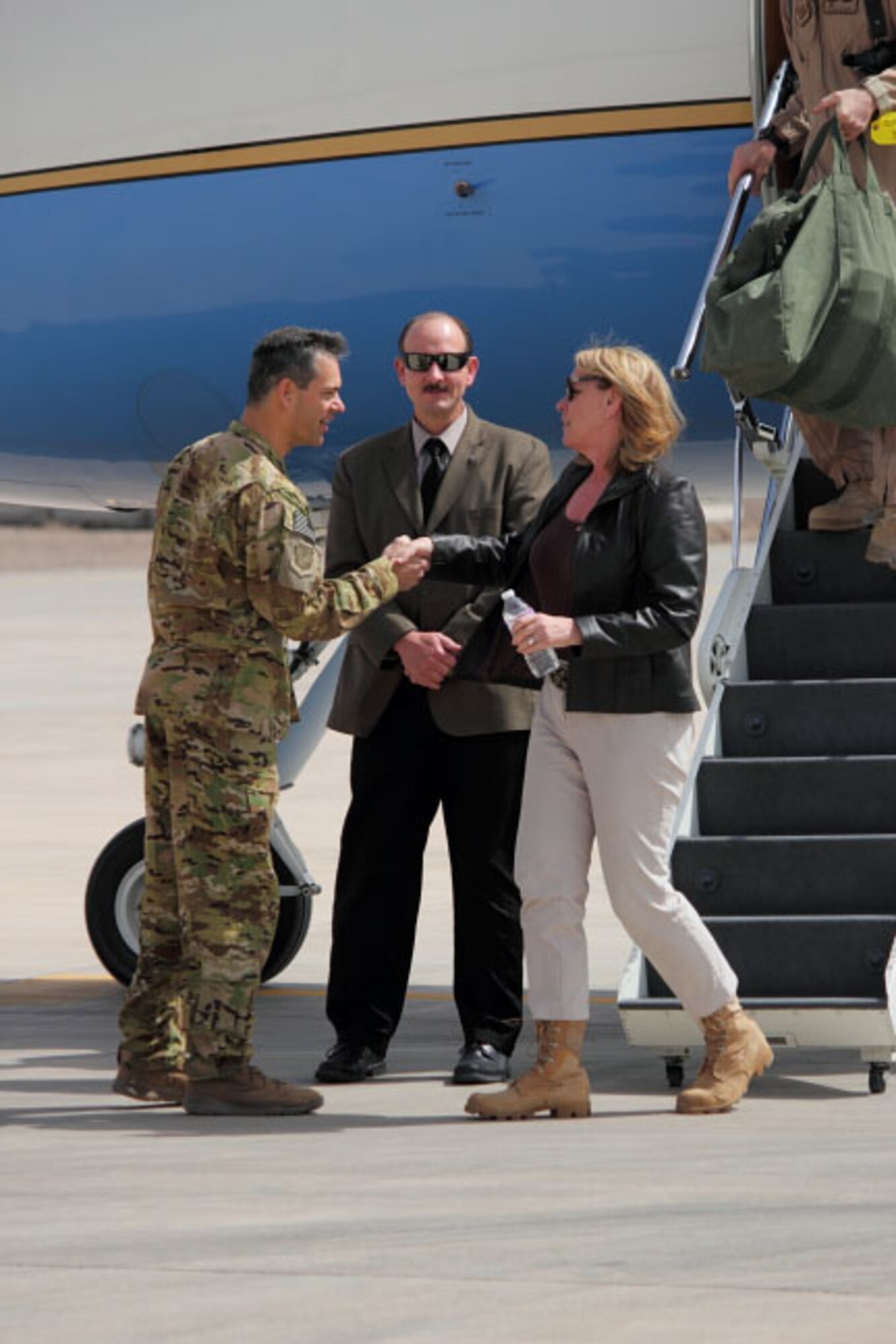 Secretary of the Air Force Deborah Lee James is greeted at Shindand Airfield, Afghanistan, by Maj. Gen. Kenneth Wilsbach, commander of the 9th Air and Space Expeditionary Task Force- Afghanistan, March 19, 2014. Shindand was the first stop on James’ first official Afghanistan tour.(U.S. Air Force photo by Senior Airman Joshua Drake/Released)