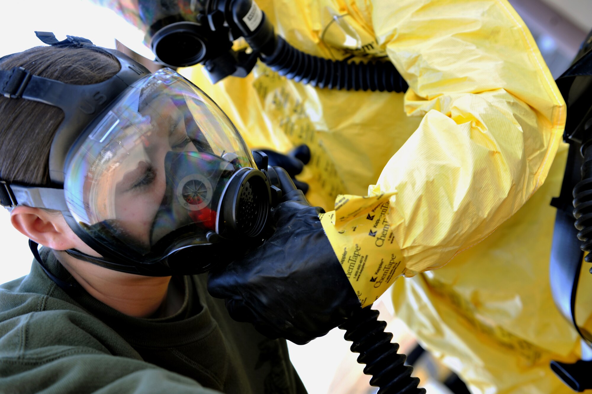 U.S. Marine Lance Cpl. Madeleine Goldsberry, Marine Wing Headquarters Squadron 1 chemical, biological, radiological and nuclear (CBRN) technician, prepares to have her gas mask taken off during a CBRN field exercise at Osan Air Base, Republic of Korea, March 21, 2014. During the field exercise, Marines and Airmen responded as a single unit to collect biological samples from various collection points across the base. (U.S. Air Force photo/Senior Airman Siuta B. Ika)