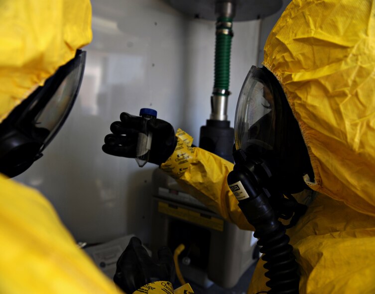 U.S. Marine Lance Cpl. Madeleine Goldsberry, Marine Wing Headquarters Squadron 1 chemical, biological, radiological and nuclear (CBRN) technician, checks a sample during a CBRN field exercise at Osan Air Base, Republic of Korea, March 21, 2014. During the field exercise, Marines and Airmen responded as a single unit to collect biological samples from various collection points across the base. (U.S. Air Force photo/Senior Airman Siuta B. Ika)