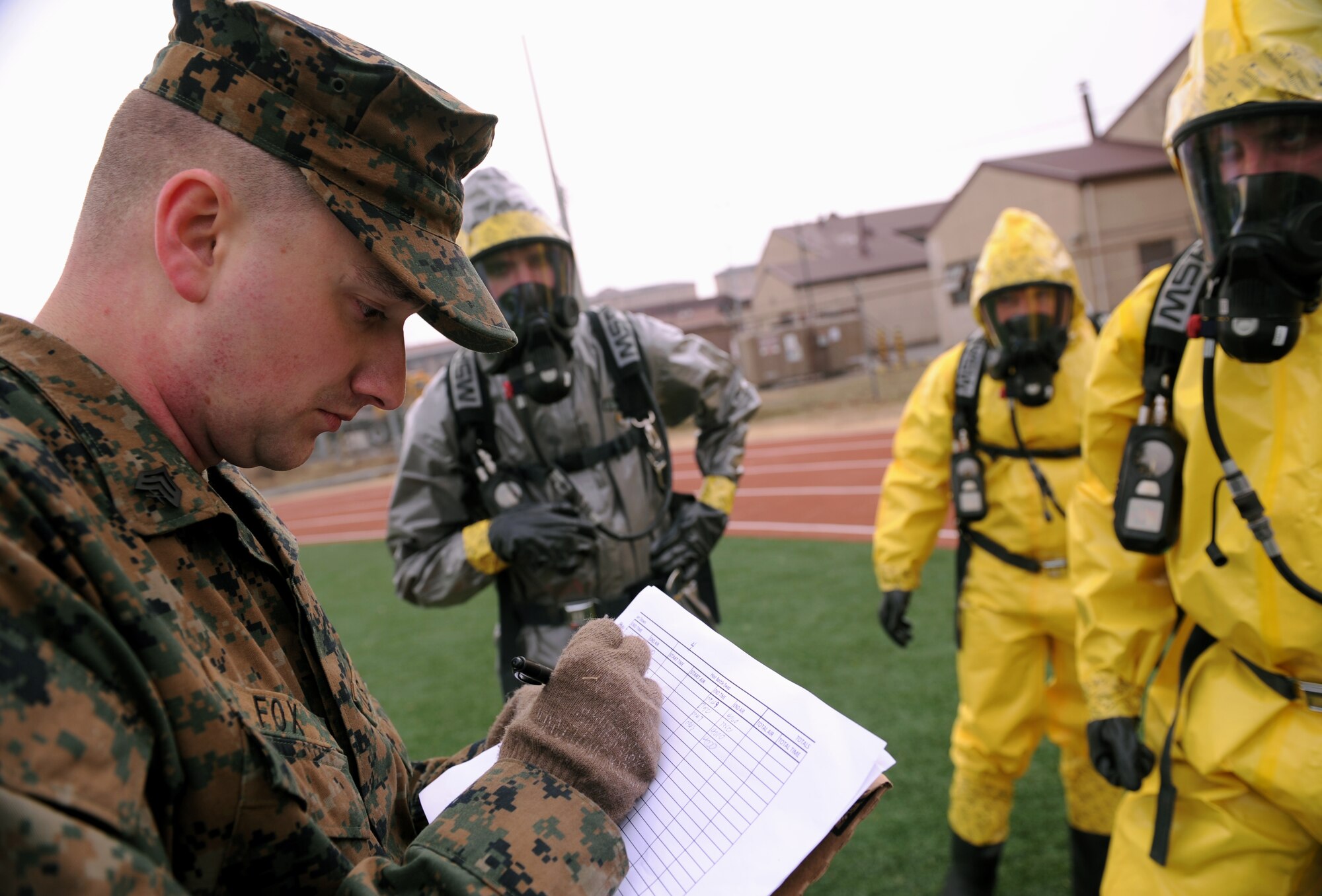 An emergency management inspector from the 1st Marine Aircraft Wing records oxygen readings during a chemical, biological, radiological and nuclear (CBRN) recon fitness competition at Osan Air Base, Republic of Korea, March 20, 2014. EM Airmen and Marines from the 1st MAW took part in multi-day academics, field equipment demonstrations, and a field exercise in addition to the CBRN recon fitness competition. (U.S. Air Force photo/Senior Airman Siuta B. Ika)