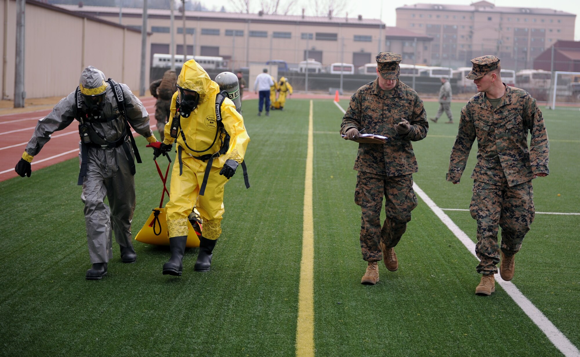 Emergency management technicians from the 51st Civil Engineer Squadron pull a simulated casualty during a chemical, biological, radiological and nuclear (CBRN) recon fitness competition at Osan Air Base, Republic of Korea, March 20, 2014. For two weeks, the EM Airmen trained with Marines from the 1st Marine Aircraft Wing out of Camp Foster, Japan, because of the organizations’ similar CBRN missions, which are used to provide combatant commanders the ability to respond and recover from any event involving hazardous materials. (U.S. Air Force photo/Senior Airman Siuta B. Ika)