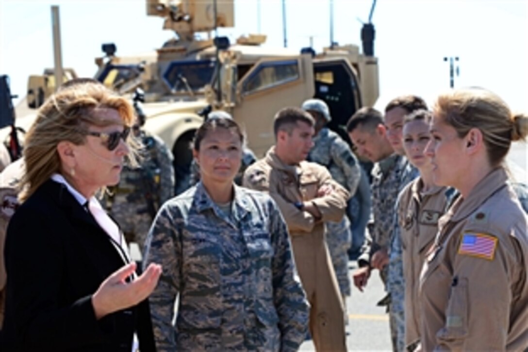 U.S. Air Force Secretary Deborah Lee James listens as U.S. Air Force Maj. Sheila Carlson, right, discusses C-130J aircraft mission capabilities at an undisclosed location in Southwest Asia, March 23, 2014. During her first visit to U.S. Air Forces Central Command as service secretary, James spoke with airmen and gained a better understanding of its area of responsibility and missions. Carlson, assistant director of operations, is assigned to the 737th Expeditionary Airlift Squadron.