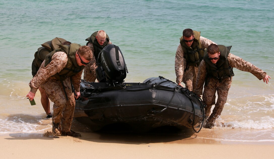 Marines drag a Combat Rubber Raiding Craft ashore March 19 during water-mobility training at the Camp Schwab Beach. The focus of the training was engineer reconnaissance to aid with construction of expeditionary bridges. The Marines are combat engineers with Company A, 9th Engineer Support Battalion, 3rd Marine Logistics Group, III Marine Expeditionary Force. 