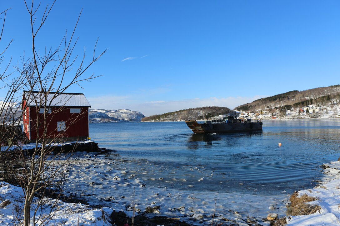 A Dutch Landing Craft Utility from the HNLMS Rotterdam transports Marines and Norwegians to a small dock during Cold Response 14. Cold Response 14 brought together nearly 16,000 troops from 16 countries to train high-intensity operations in the unique climate above the Arctic Circle and strengthen the alliance of partners and their commitment to global security in every clime and place.