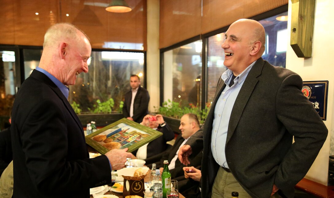 Lieutenant Gen. Richard Tryon, commander of U.S. Marine Corps Forces Command and U.S. Marine Corps Forces, receives a gift from Georgian Maj. Gen. Vakhtang Kapanadze, the Georgian chief of defense during a Georgian-hosted dinner for Tryon and his staff, March 20, 2014. Tryon visited Georgia to attend the departure ceremony for the Georgian Special Mountain Battalion and 23rd Bn., and he also met with Georgian military officials during his time. (Official Marine Corps photo by Lance Cpl. Scott W. Whiting, BSRF PAO/ Released)