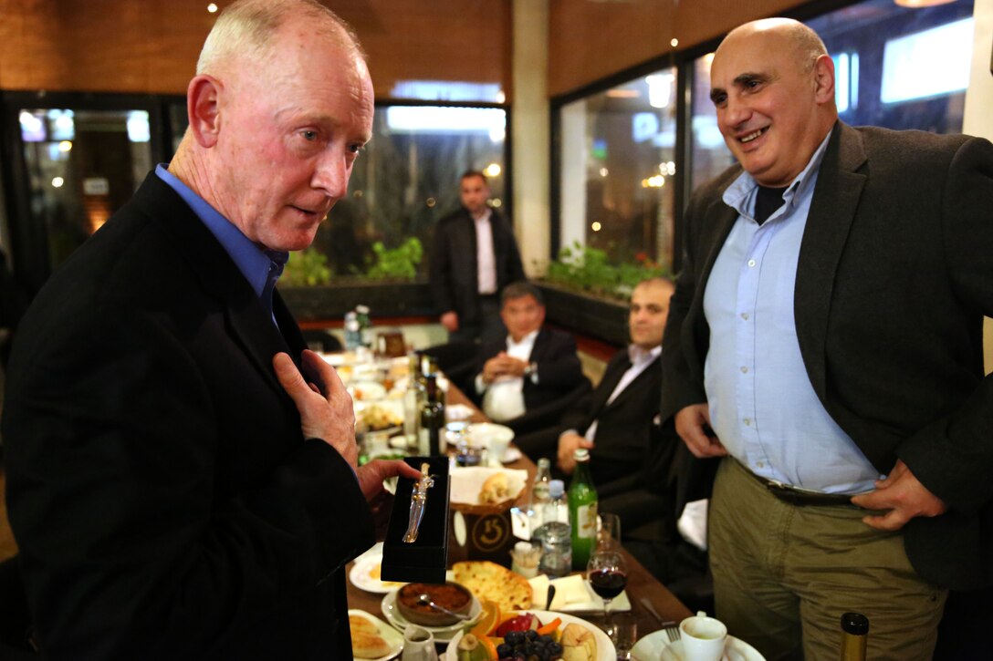 Lieutenant Gen. Richard Tryon, commander of U.S. Marine Corps Forces Command and U.S. Marine Corps Forces presents Georgian Maj. Gen. Vakhtang Kapanadze, the Georgian chief of defense, with a miniature Mameluke Sword during a Georgian-hosted dinner for Tryon and his staff, March 20, 2014. Tryon visited Georgia to attend the departure ceremony for the Georgian Special Mountain Battalion and 23rd Bn., and he also met with Georgian military officials during his time. (Official Marine Corps photo by Lance Cpl. Scott W. Whiting, BSRF PAO/ Released)