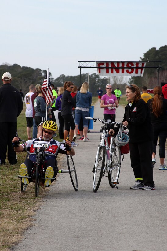 Paul Kelly sits in his hand-cycle at the finish line after completing the15th Annual Marine Corps Air Station Cherry Point Half Marathon March 22, 2014. Kelly started participating in various races and events in 2008 with the hopes of raising money and awareness for wounded service members.
