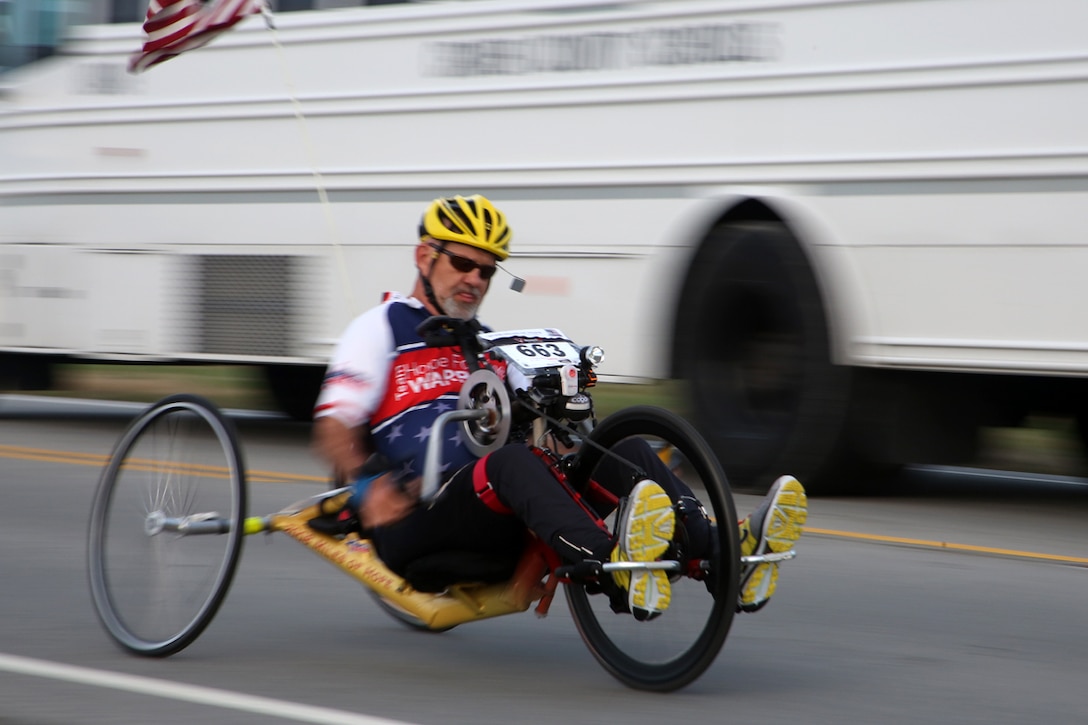 Paul Kelly rides his hand-crank bicycle during the 15th Annual Marine Corps Air Station Cherry Point Half Marathon March 22, 2014. Kelly finished with a time just under 1:40:00. Knowing there are Marines running behind him encourages Kelly to push harder during races.
