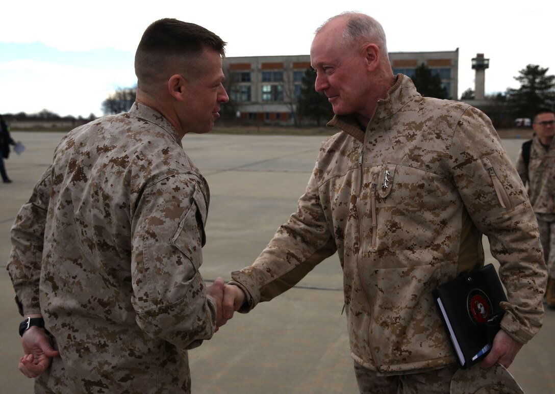 Lieutenant Col. Trevor Hall, commanding officer of 3rd Battalion, 8th Marine Regiment, 2nd Marine Division assigned to Black Sea Rotational Force 14, welcomes Lt. Gen. Richard Tryon, commander of U.S. Marines Forces Command and U.S. Marine Corps Forces, Europe, to Mihail Kogalniceanu Air Base, Romania, March 17, 2014. Tryon visited the base to speak to the Marines on BSRF-14 and to tour the installation. Black Sea Rotational Force 14 is a contingent of Marines and sailors tasked with maintaining positive relations with partner nations, regional stability and increasing interoperability while providing the capability for rapid crisis response, as directed by U.S. European Command, in the Black Sea, Balkan and Caucasus regions of Eastern Europe. (Official Marine Corps photo by Lance Cpl. Scott W. Whiting, BSRF PAO/ Released)