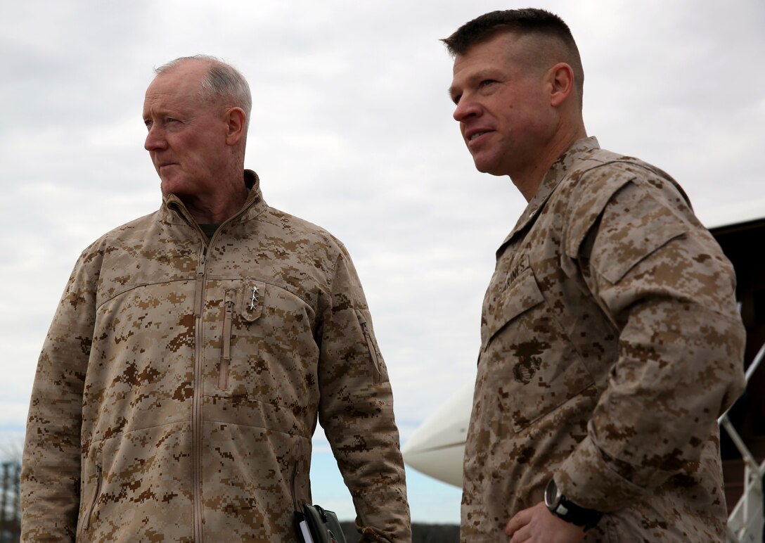 Lieutenant Col. Trevor Hall, commanding officer of 3rd Battalion, 8th Marine Regiment, 2nd Marine Division assigned to Black Sea Rotational Force 14, welcomes Lt. Gen. Richard Tryon, commander of U.S. Marines Forces Command and U.S. Marine Corps Forces, Europe, to Mihail Kogalniceanu Air Base, Romania, March 17, 2014. Tryon visited the base to speak to the Marines on BSRF-14 and to tour the installation. Black Sea Rotational Force 14 is a contingent of Marines and sailors tasked with maintaining positive relations with partner nations, regional stability and increasing interoperability while providing the capability for rapid crisis response, as directed by U.S. European Command, in the Black Sea, Balkan and Caucasus regions of Eastern Europe. (Official Marine Corps photo by Lance Cpl. Scott W. Whiting, BSRF PAO/ Released)