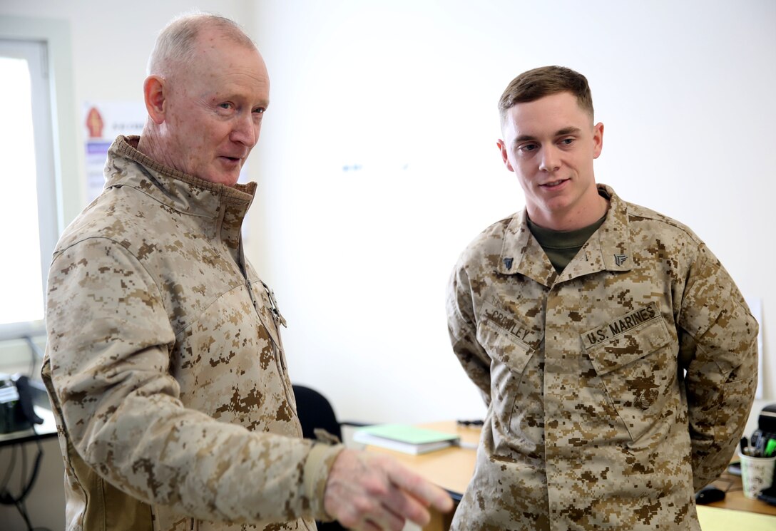 Lieutenant Gen. Richard Tryon, commander of U.S. Marines Forces Command and U.S. Marine Corps Forces, Europe, speaks with Cpl. Christopher Crowley, a Marine with 3rd Battalion, 8th Marine Regiment, 2nd Marine Division assigned to Black Sea Rotational Force 14, aboard Mihail Kogalniceanu Air Base, Romania, March 17, 2014. Tryon visited the installation to meet the Marines and tour the base, talking with Marines as he visited the different sections aboard the air base. Black Sea Rotational Force 14 is a contingent of Marines and sailors tasked with maintaining positive relations with partner nations, regional stability and increasing interoperability while providing the capability for rapid crisis response, as directed by U.S. European Command, in the Black Sea, Balkan and Caucasus regions of Eastern Europe. (Official Marine Corps photo by Lance Cpl. Scott W. Whiting, BSRF PAO/ Released)
