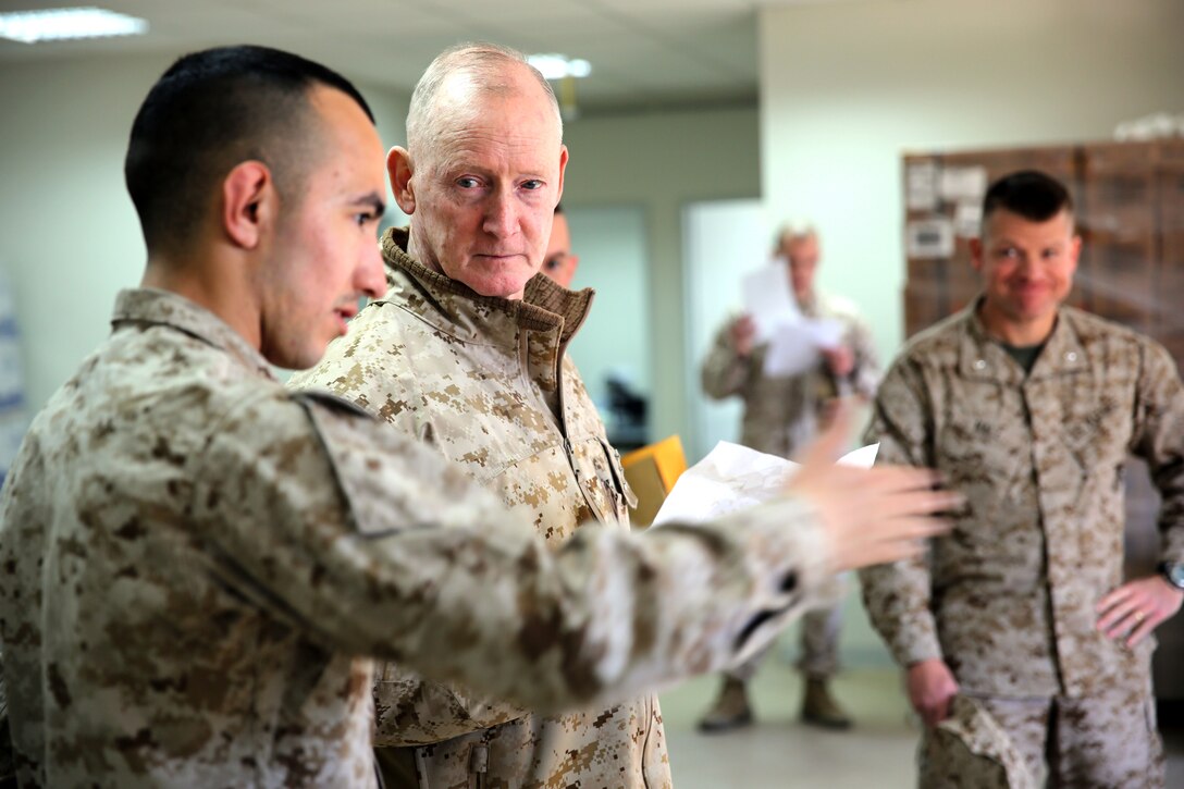 Lieutenant Gen. Richard Tryon, commander of U.S. Marines Forces Command and U.S. Marine Corps Forces, Europe, speaks with Cpl. Jonathan Orozco, a food service specialist with 3rd Battalion, 8th Marine Regiment, 2nd Marine Division assigned to Black Sea Rotational Force 14, aboard Mihail Kogalniceanu Air Base, Romania, March 17, 2014. Tryon visited the installation to meet the Marines and tour the base, talking with Marines as he visited the different sections aboard the air base. Black Sea Rotational Force 14 is a contingent of Marines and sailors tasked with maintaining positive relations with partner nations, regional stability and increasing interoperability while providing the capability for rapid crisis response, as directed by U.S. European Command, in the Black Sea, Balkan and Caucasus regions of Eastern Europe. (Official Marine Corps photo by Lance Cpl. Scott W. Whiting, BSRF PAO/ Released)