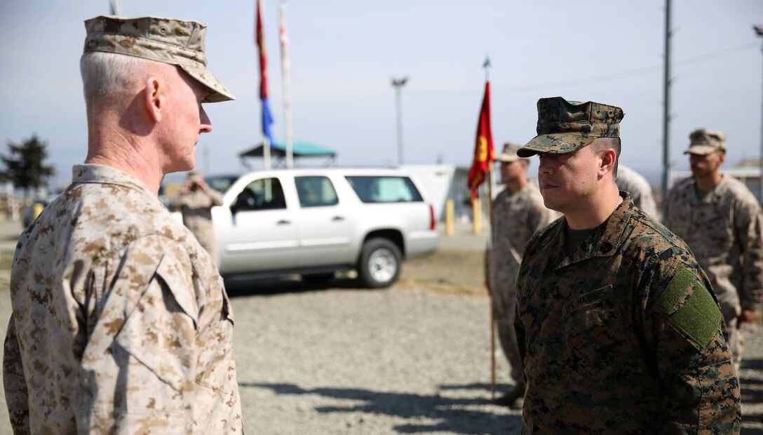 Lieutenant Gen. Richard Tryon, commander of U.S. Marine Corps Forces Command and U.S. Marine Corps Forces, Europe, promotes Master Sgt. Mario Lopez-Diaz, the senior enlisted advisor of Georgian Liaison Team 12 during his frocking ceremony March 20, 2014 aboard the Krstanisi National Training Center in Georgia. Georgian Liaison Team 12 is slated to deploy to Afghanistan as part of the International Security Assistance Force. Lopez-Diaz was frocked, which means he will wear the rank of master sergeant to fulfill his job position’s requirements, but will not receive any pay increase until he officially is promoted. (Official Marine Corps photo by Lance Cpl. Scott W. Whiting, BSRF PAO/ Released)