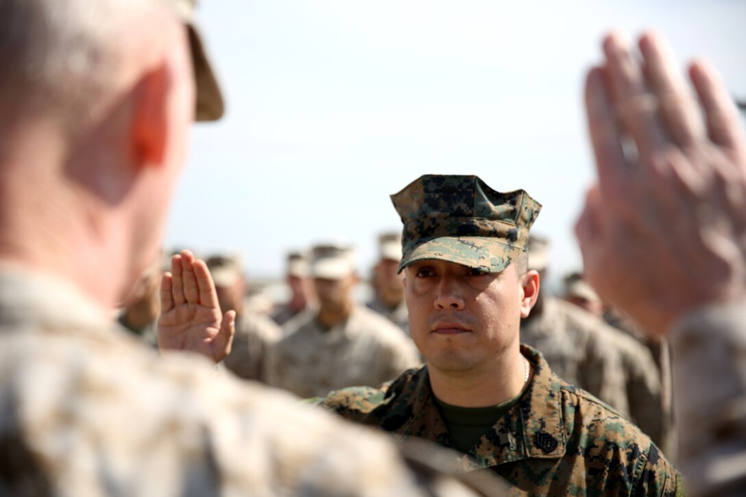Lieutenant Gen. Richard Tryon, commander of U.S. Marine Corps Forces Command and U.S. Marine Corps Forces, Europe, promotes Master Sgt. Mario Lopez-Diaz, the senior enlisted advisor of Georgian Liaison Team 12 during his frocking ceremony March 20, 2014 aboard the Krstanisi National Training Center in Georgia. Georgian Liaison Team 12 is slated to deploy to Afghanistan as part of the International Security Assistance Force. Lopez-Diaz was frocked, which means he will wear the rank of master sergeant to fulfill his job position’s requirements, but will not receive any pay increase until he officially is promoted. (Official Marine Corps photo by Lance Cpl. Scott W. Whiting, BSRF PAO/ Released)