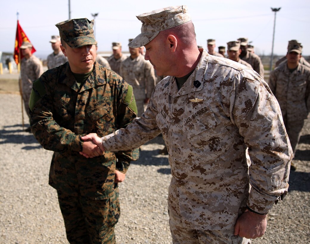 Master Gunnery Sgt. Troy Allen, the senior enlisted advisor of the Georgian Training Team, and Master Sgt. Mario Lopez-Diaz, the senior enlisted advisor of Georgian Liaison Team 12, shake hands after Lopez-Diaz’s frocking ceremony March 20, 2014 aboard the Krstanisi National Training Center in Georgia. Georgian Liaison Team 12 is slated to deploy to Afghanistan as part of the International Security Assistance Force. Lopez-Diaz was frocked, which means he will wear the rank of master sergeant to fulfill his job position’s requirements, but will not receive any pay increase until he officially is promoted. (Official Marine Corps photo by Lance Cpl. Scott W. Whiting, BSRF PAO/ Released)