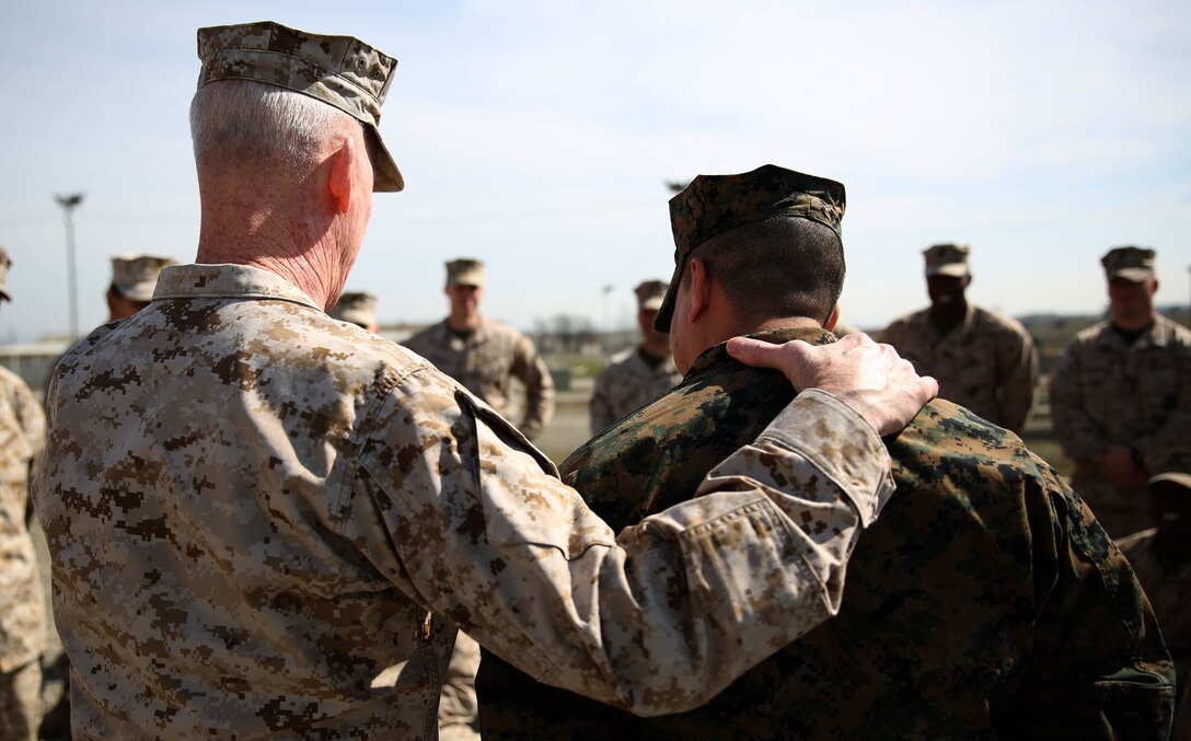 Lieutenant Gen. Richard Tryon, commander of U.S. Marine Corps Forces Command and U.S. Marine Corps Forces, Europe, congratulates Master Sgt. Mario Lopez-Diaz, the senior enlisted advisor of Georgian Liaison Team 12, on being frocked to the rank of master sergeant March 20, 2014 aboard the Krstanisi National Training Center in Georgia. Georgian Liaison Team 12 is slated to deploy to Afghanistan as part of the International Security Assistance Force. Lopez-Diaz was frocked, which means he will wear the rank of master sergeant to fulfill his job position’s requirements, but will not receive any pay increase until he officially is promoted. (Official Marine Corps photo by Lance Cpl. Scott W. Whiting, BSRF PAO/ Released)
