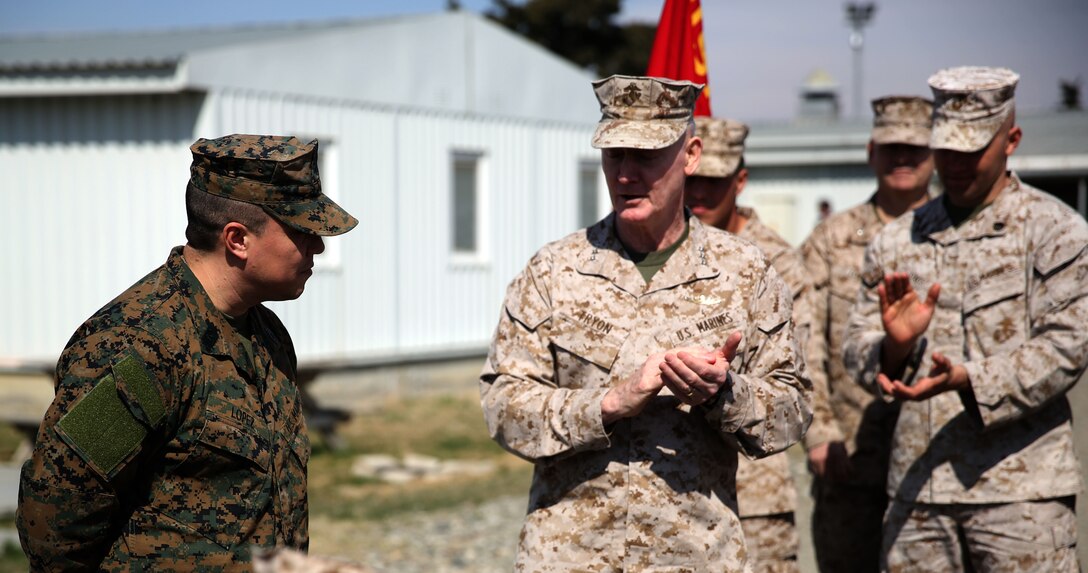 Lieutenant Gen. Richard Tryon, commander of U.S. Marine Corps Forces Command and U.S. Marine Corps Forces, Europe, congratulates Master Sgt. Mario Lopez-Diaz, the senior enlisted advisor of Georgian Liaison Team 12, on being frocked to the rank of master sergeant March 20, 2014 aboard the Krstanisi National Training Center in Georgia. Georgian Liaison Team 12 is slated to deploy to Afghanistan as part of the International Security Assistance Force. Lopez-Diaz was frocked, which means he will wear the rank of master sergeant to fulfill his job position’s requirements, but will not receive any pay increase until he officially is promoted. (Official Marine Corps photo by Lance Cpl. Scott W. Whiting, BSRF PAO/ Released)