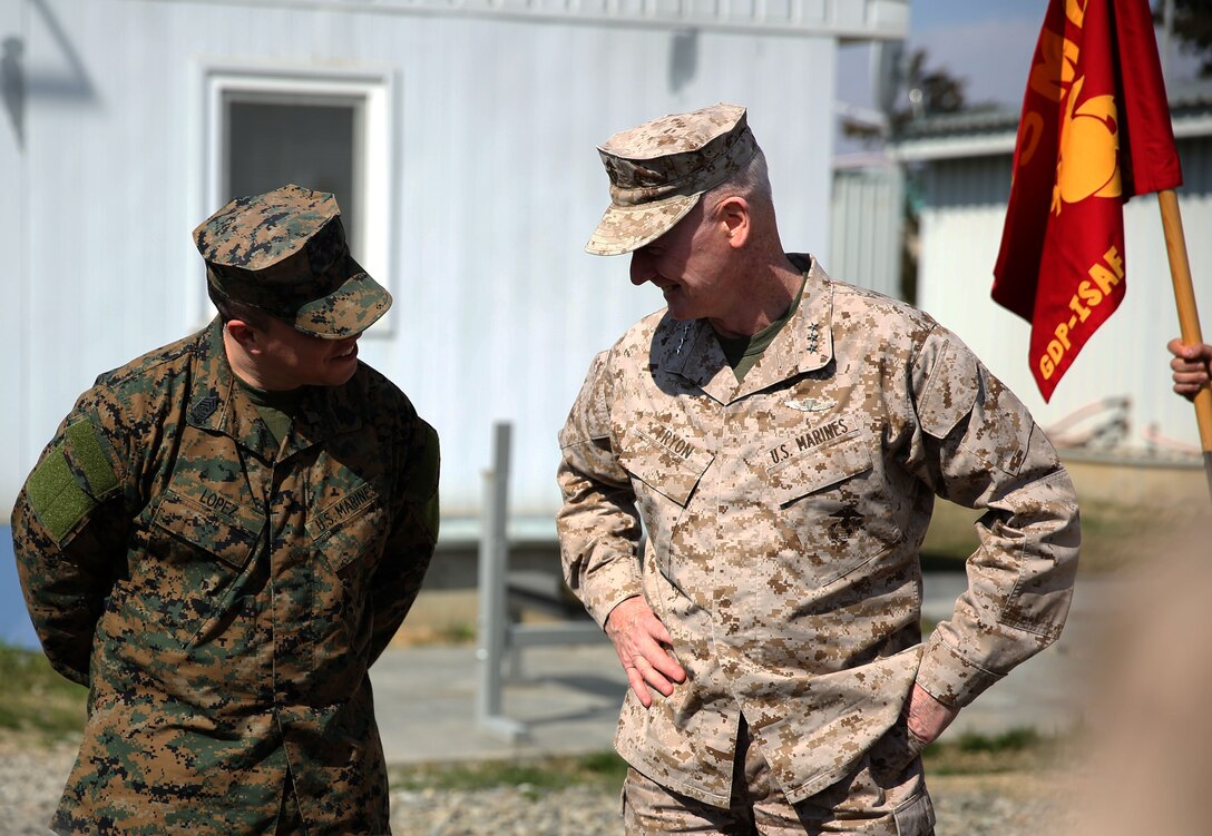 Lieutenant Gen. Richard Tryon, commander of U.S. Marine Corps Forces Command and U.S. Marine Corps Forces, Europe, congratulates Master Sgt. Mario Lopez-Diaz, the senior enlisted advisor of Georgian Liaison Team 12, on being frocked to the rank of master sergeant March 20, 2014 aboard the Krstanisi National Training Center in Georgia. Georgian Liaison Team 12 is slated to deploy to Afghanistan as part of the International Security Assistance Force. Lopez-Diaz was frocked, which means he will wear the rank of master sergeant to fulfill his job position’s requirements, but will not receive any pay increase until he officially is promoted. (Official Marine Corps photo by Lance Cpl. Scott W. Whiting, BSRF PAO/ Released)