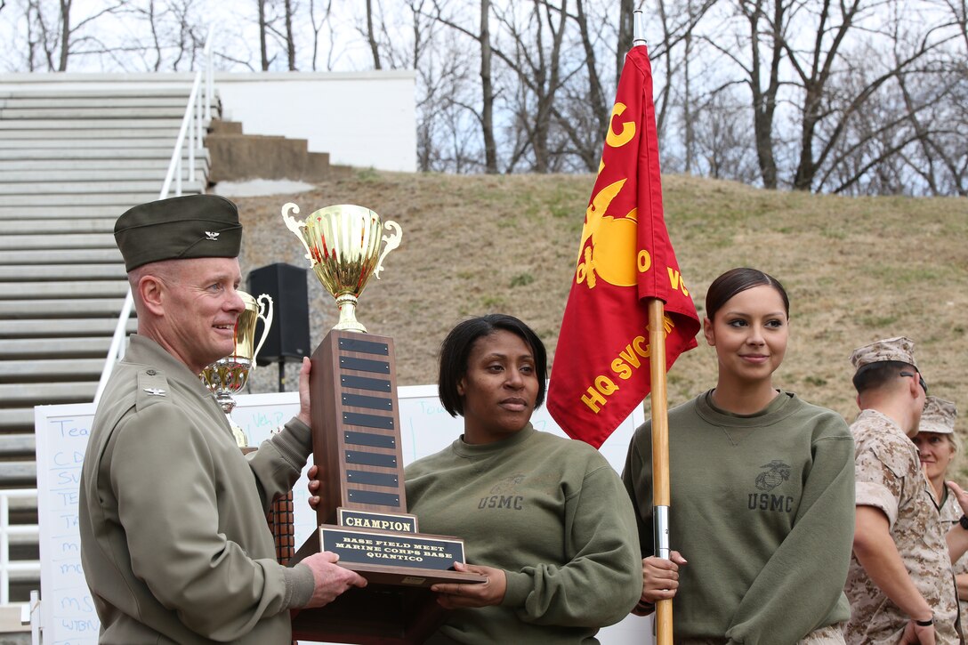 Col. David Maxwell, the base commander for Marine Corps Base Quantico, presents the championship trophy to the Marines of Service Co., Headquarters and Service Bn., after they won the first-ever base field meet in Butler Stadium on March 21, 2014. Service Co. won the meet by taking first in tug-of-war, the final event of the day.