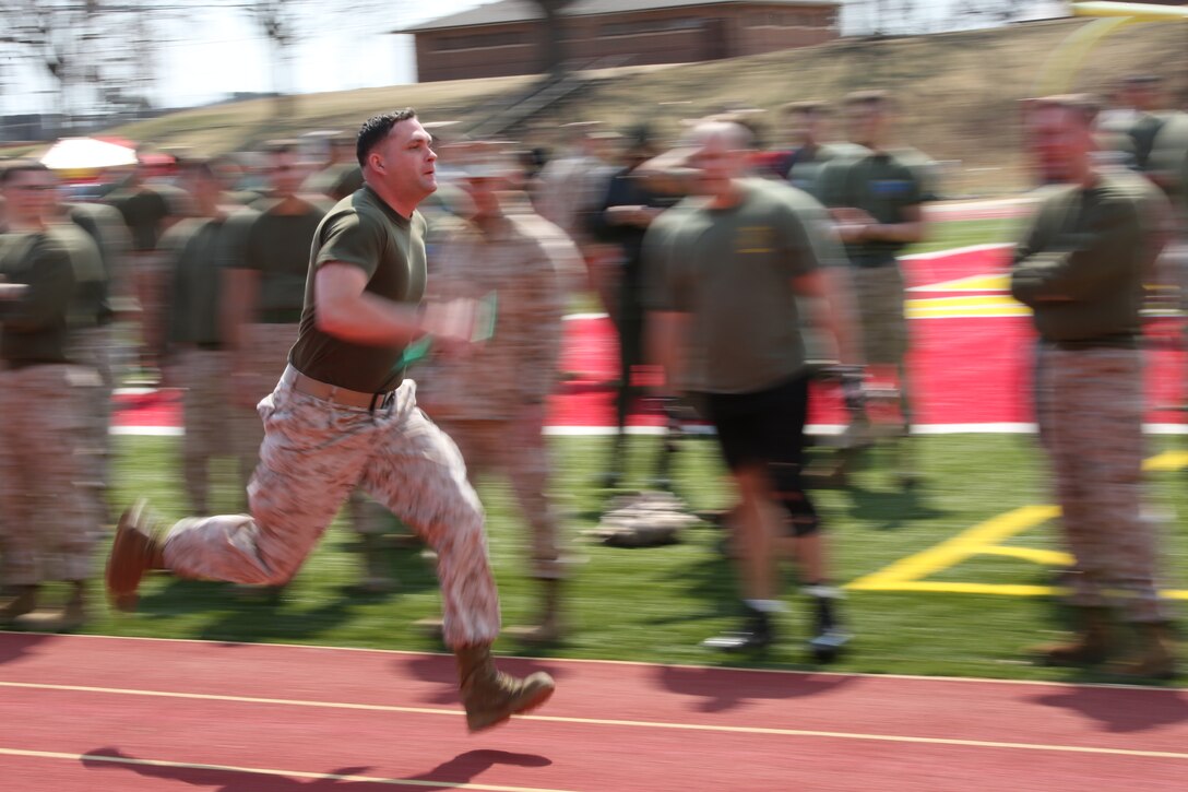 A Marine from Marine Corps Base Quantico runs a lap during a mile relay race for the basewide field meet held at Butler Stadium on March 21, 2014. The base came together to compete in multiple events that included relays, games and a tug-of-war.