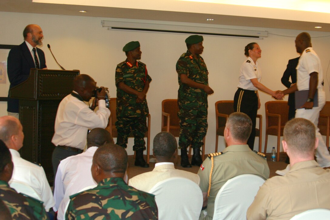 Brig. Gen. Jody Daniels, deputy director for intelligence of U.S. Africa Command, presents a certificate to Navy Lt. Jorim Disengomoka, a Canadian Military Intelligence Basic Officer’s Course-Africa instructor during a graduation ceremony, March 19. The current MIBOC-A is the tenth iteration of the program and is U.S. Africa Command’s flagship intelligence building course to enhance multinational interoperability between partners on the African continent. 
