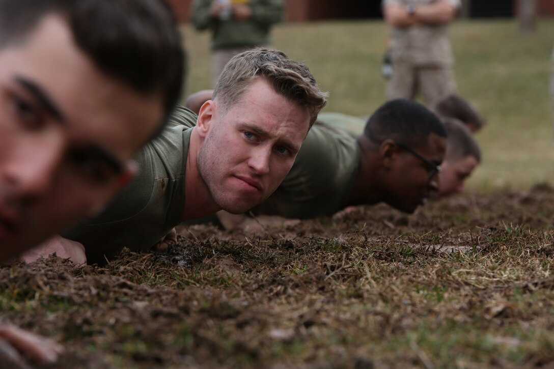 The Marines of Service Co., Headquarters and Service Bn., wait to grab the rope for the tug-of-war event of the Marine Corps Base Quantico basewide field meet held at Butler Stadium. Service Co. won the event which secured their overall victory for the meet.