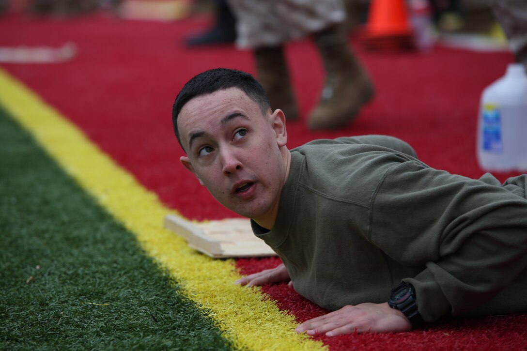 Lance Cpl. Jonathan Cerecedes from Special Reaction Team, Security Bn., prepares to begin the maneuver under fire section of the Marine Combat Fitness Test for the Marine Corps Base Quantico basewide field meet held at Butler Stadium on March 21, 2014. More than 15 teams competed in the meet with Service Co., Headquarters and Service Bn., winning the whole event. 