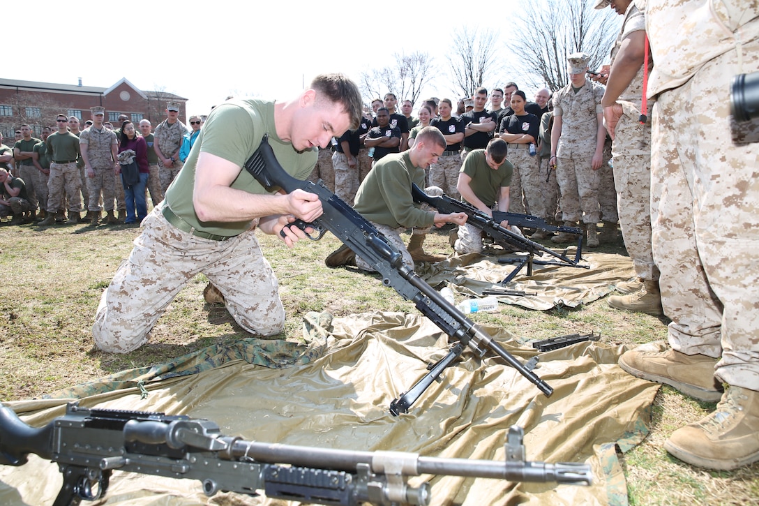 A Marine disassembles a M240B automatic weapon system during the basewide field meet held on March 21, 2014, at Butler Stadium. Several teams from all over the base competed in the event.