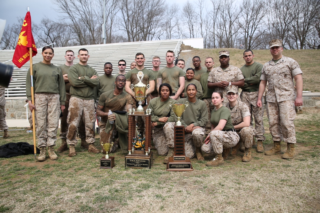 Service Co., Headquarters and Service Bn., pose with the championship trophies for the Marine Corps Base Quantico basewide field meet on March 21, 2014, at Butler Stadium. More than 15 teams competed in the meet with Service Co. winning the overall event.