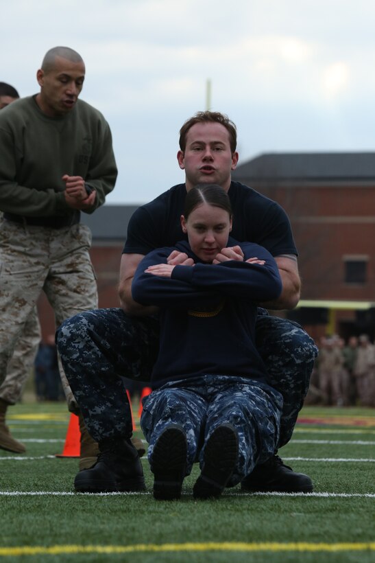 The Navy corpsmen stationed on Marine Corps Base Quantico, perform the maneuver under fire section of the Marines Combat Fitness Test during the basewide field meet held at Butler Stadium on March 21, 2014. They were the only non-Marine team to compete in the meet and placed in two events, weapons assembly and an exercise relay.