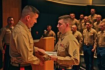 Brig. Gen. James Bierman, Commanding General, Marine Corps Recruit Depot, San Diego and Western Recruiting Region, presents Sgt. Matthew Kitsch, MEPS liaison, Recruiting Station Lansing, with a Meritorious Mast in Lansing, Mich. March, 25. Kitsch was recognized for his performance as a new liaison, in the absence of his supervisor, during five ship weeks in the months of January and February 2014. 