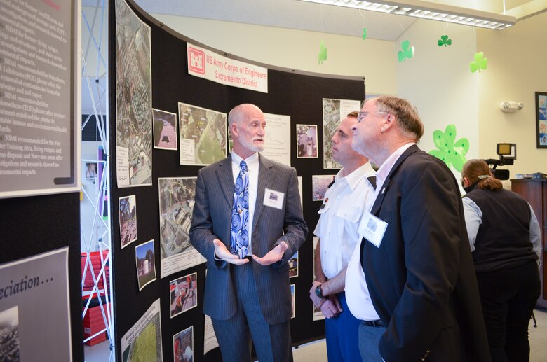 U.S. Army Corps of Engineers Sacramento District project manager Jerry Vincent (left) converses with U.S. Rep. Sam Farr (far right) during the final public meeting for former Naval Auxiliary Air Station Monterey groundwater cleanup project March 19, 2014 at the Casanova-Oak Knolls Community Center in Monterey, Calif.