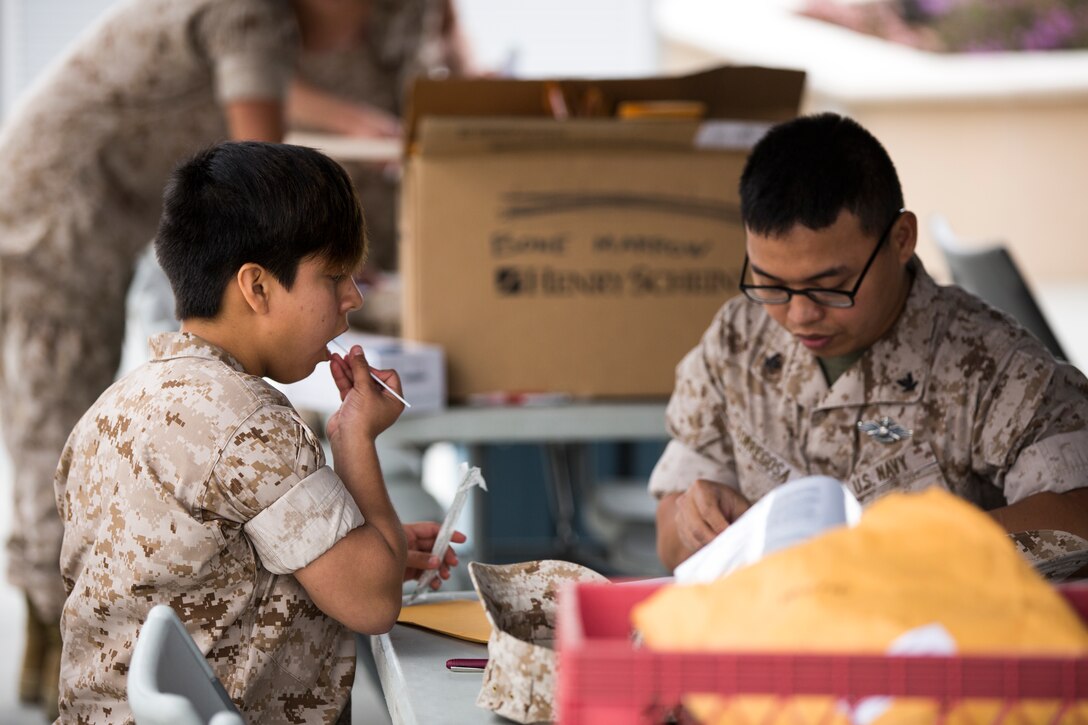 Cpl. Jo Larraga, Marine Corps property specialist with Marine Air Group 16, swabs her mouth for a bone marrow donation application aboard Marine Corps Air Station Miramar, Calif., March 25. The Naval Medical Center San Diego holds blood drives aboard the air station for anyone to donate. 