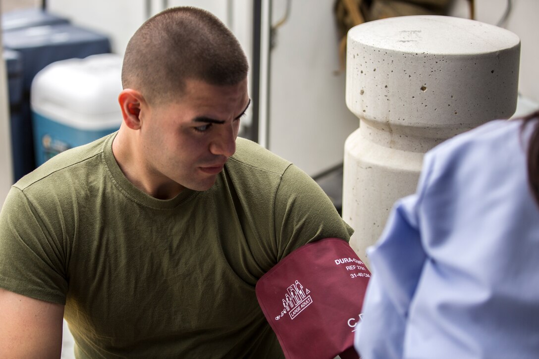 Lance Cpl. Jeremy Sanabria, data technician with station data communications, gets his vitals checked before donating blood aboard Marine Corps Air Station Miramar, Calif., March 25. Marines and Sailors participated in a blood drive held by the Naval Medical Center San Diego aboard the air station.