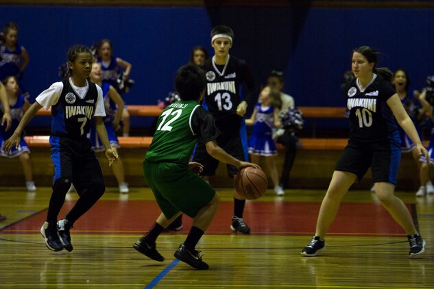 A member of J-Money attempts to score a basket during the final game of the youth sports basketball season inside IronWorks Gym sports court, March 13, 2014, aboard Marine Corps Air Station Iwakuni, Japan. The double elimination game was part of the 13 to 15-year-old division championship in which the Dark Knights won 21-20.