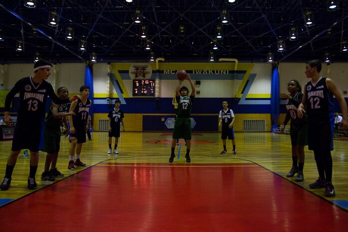 A member of J-Money attempts a free throw during the final game of the youth sports basketball season, March 13, 2014, inside the IronWorks Gym sports court aboard Marine Air Station Iwakuni, Japan. The double elimination match-up was part of the 13 to 15-year-old division hosted by Marine Corps Community Services.