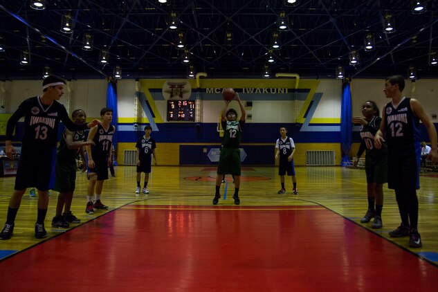 A member of J-Money attempts a free throw during the final game of the youth sports basketball season, March 13, 2014, inside the IronWorks Gym sports court aboard Marine Air Station Iwakuni, Japan. The double elimination match-up was part of the 13 to 15-year-old division hosted by Marine Corps Community Services.