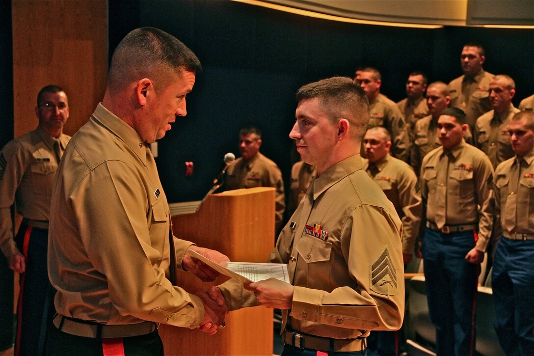 Brig. Gen. James Bierman, Commanding General, Marine Corps Recruit Depot, San Diego and Western Recruiting Region, presents Sgt. Matthew Kitsch, MEPS liaison, Recruiting Station Lansing, with a Meritorious Mast in Lansing, Mich. March, 25. Kitsch was recognized for his performance as a new liaison, in the absence of his supervisor, during five ship weeks in the months of January and February 2014. 