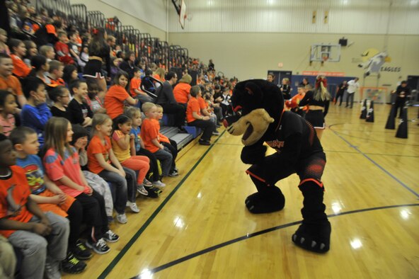 The University of Cincinnati Bearcat mascot dances in front of children during an assembly at Michael Anderson Elementary School on Fairchild Air Force Base, Wash., March 19, 2014. University of Cincinnati cheerleaders and a pep band came to Fairchild during their visit to Spokane, Wash. for the National Collegiate Althetic Association Tournament to visit with Airmen and boost morale around the base. (U.S. Air Force photo by Senior Airman Mary O'Dell/Released)
