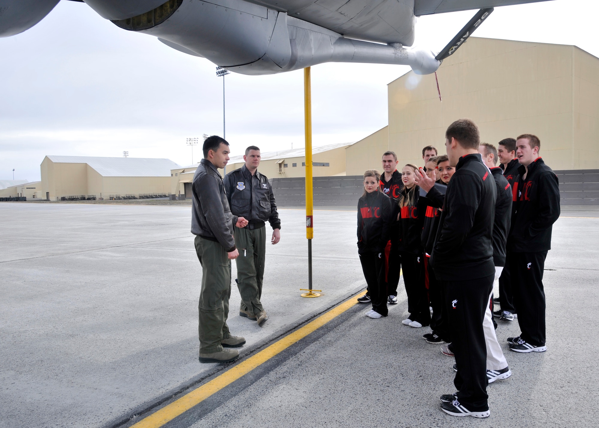 Visitors from the University of Cincinnati speak with crew members during a tour of a KC-135 Stratotanker at Fairchild Air Force Base, Wash., March 19, 2014. Cheerleaders, band members and the Bearcat mascot visited Fairchild to perform around base and visit with Airmen. (U.S. Air Force photo by Airman 1st Class Janelle Patino/Released)