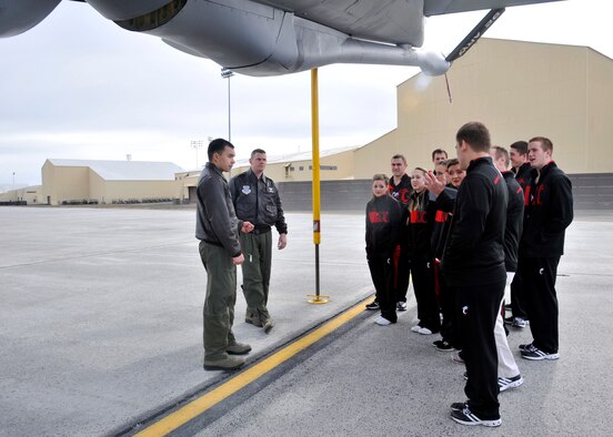 Visitors from the University of Cincinnati speak with crew members during a tour of a KC-135 Stratotanker at Fairchild Air Force Base, Wash., March 19, 2014. Cheerleaders, band members and the Bearcat mascot visited Fairchild to perform around base and visit with Airmen. (U.S. Air Force photo by Airman 1st Class Janelle Patino/Released)