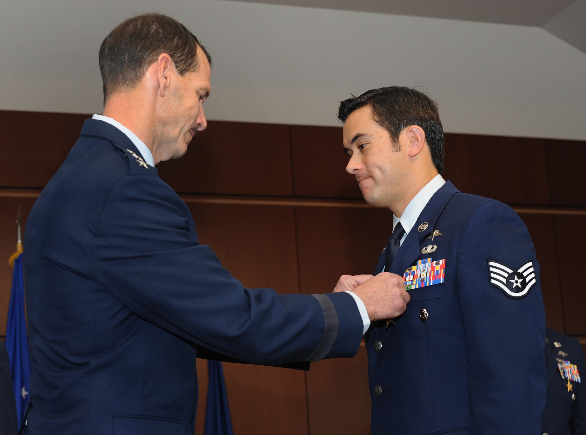 Air National Guard Director Lt. Gen. Stanley E. Clark III, presents the Bronze Star medal to Staff Sgt. Christopher Jones, a combat controller with the Oregon Air National Guard's 125th Special Tactics Squadron, during a ceremony at the 41st Infantry Division Armed Forces Reserve Center at Camp Withycombe, in Clackamas, Ore., March 24, 2014. (U.S. Air National Guard photo by Tech. Sgt. John Hughel, 142nd Fighter Wing Public Affairs/Released)