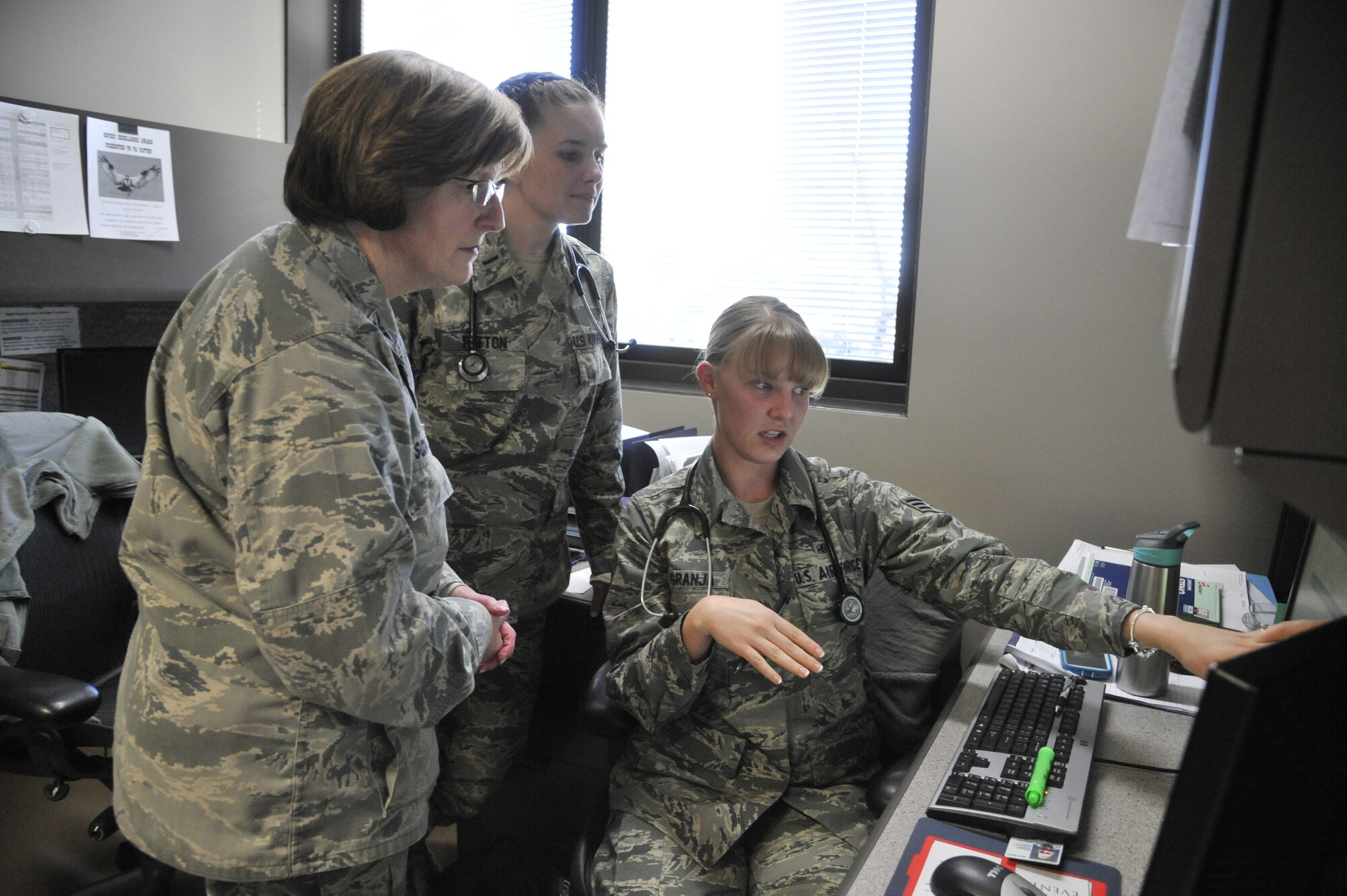 Col. Robin Schultze, 92nd Medical Group commander, speaks with an Airman at Fairchild Air Force Base, Wash., Feb. 21, 2014. She has traveled to nearly every continent during her career in the Air Force and will be at 28 years time in-service after her current assignment. (U.S. Air Force photo by Senior Airman Mary O'Dell/Released)